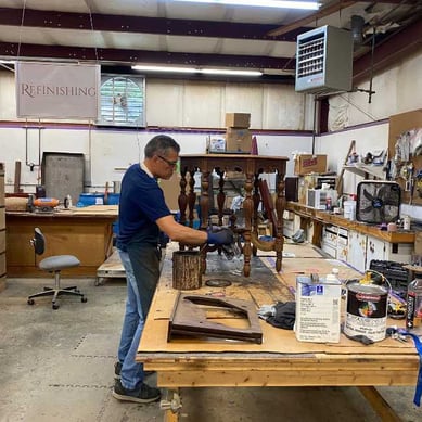 A Furniture Refinisher Staining an Antique Octagonal Table - furniture restoration
