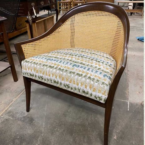 A chair with traditional mat caning and a modern design