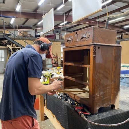 Cristian repairs drawers on antique table; furniture repair; custom woodwork; raleigh, nc