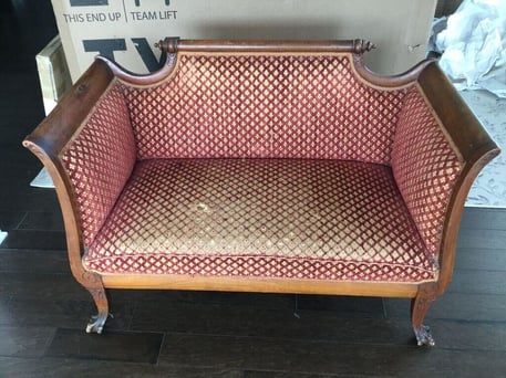 an antique setteee before reupholstery
