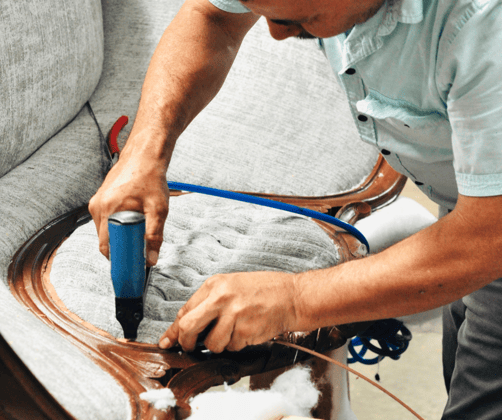 Juan, our upholsterer, working on settee - upholstery