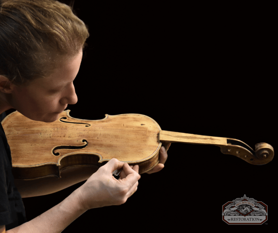 craftsperon sarah repairing a violin - instrument repair