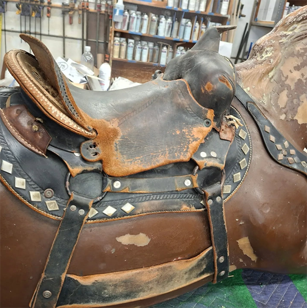 leather saddle before repair, restoration, and leather tooling