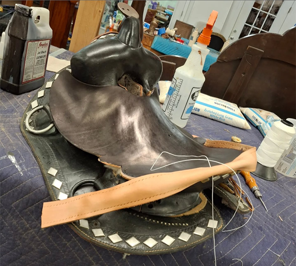 stitching new edge around leather saddle