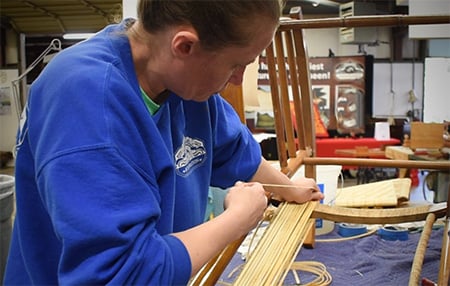 Craftsperson Sarah working in the Mumford Restoration workshop